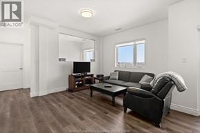 Lasalle condo for rent - A living room with a black couch and a television.