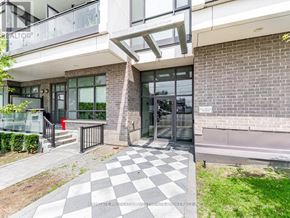 Toronto (Yorkdale-Glen Park) condo for rent - A modern building with a glass door and a checkered floor in front.