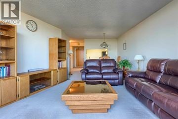 Burnaby apartment for rent - A living room with a brown leather couch and a wooden coffee table.