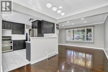 Windsor apartment for rent - A kitchen with black cabinets and a wooden floor.