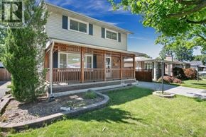 Windsor apartment for rent - A house with a white siding and a brown deck.