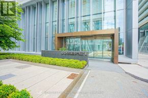 Toronto (Church-Yonge Corridor) condo for rent - The front of a building with glass windows and a wooden entrance.