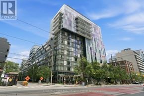 Toronto (Waterfront Communities) condo for rent - A modern multi-story building with a glass facade is the main focus of the image.
