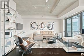 Toronto (Waterfront Communities) condo for rent - A modern living room with a glass table and a black and white checkered rug.