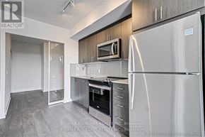Oshawa (Windfields) condo for rent - A modern kitchen with a stainless steel refrigerator and oven.