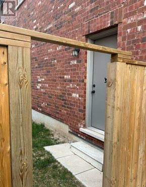Milton (Fo Ford) apartment for rent - A wooden fence in front of a brick building.