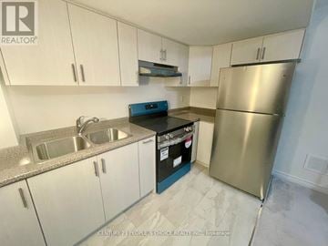 Milton (Fo Ford) apartment for rent - A kitchen with white cabinets and a stainless steel refrigerator.