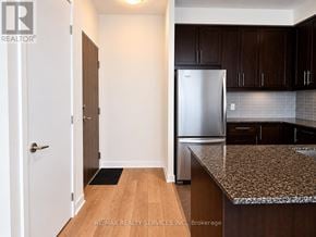 Mississauga (City Centre) condo for rent - A kitchen with a refrigerator, cabinets, and a countertop.