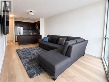 Mississauga (City Centre) condo for rent - A living room with a grey couch and a black speaker.