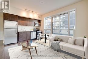 Toronto (Mimico) condo for rent - A modern kitchen with a refrigerator, microwave, and oven.