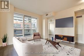 Toronto (Mimico) condo for rent - A living room with a white couch, a brown chair, and a wooden coffee table.