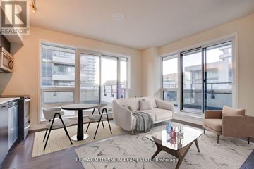 Toronto (Mimico) condo for rent - A modern living room with a glass table and a sofa.