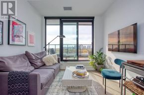 Toronto (Junction Area) condo for rent - A living room with a purple couch and a coffee table with magazines on it.