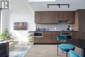 Toronto (Junction Area) condo for rent - A modern kitchen with a dining table and chairs.