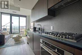 Toronto (Junction Area) condo for rent - A modern kitchen with a large island and stainless steel appliances.