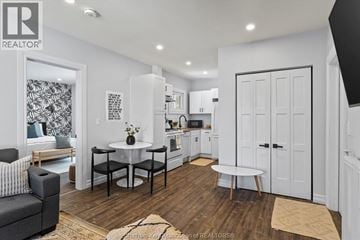 Chatham apartment for rent - A modern kitchen with white cabinets and a black and white patterned wallpaper in the background.