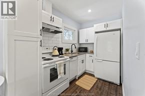 Chatham apartment for rent - A white kitchen with a refrigerator, oven, and microwave.