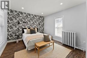 Chatham apartment for rent - A bedroom with a patterned wallpaper and a bed with a wooden frame.