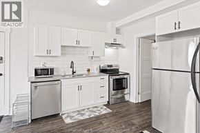 Chatham apartment for rent - A kitchen with white cabinets and appliances.