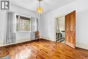 Hamilton apartment for rent - A room with a wooden floor and a wooden door.