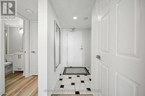London East (East F) condo for rent - A hallway with a checkered floor mat and white walls.