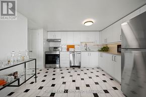 London East (East F) condo for rent - A kitchen with black and white checkered floor and white cabinets.