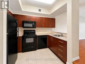 Ottawa condo for rent - A kitchen with black appliances and wooden cabinets.