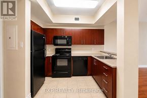 Ottawa condo for rent - A kitchen with wooden cabinets and black appliances.