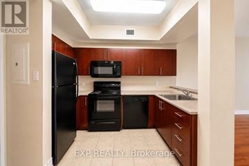 Ottawa condo for rent - A kitchen with wooden cabinets and black appliances.