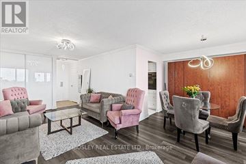 Toronto (Crescent Town) condo for rent - A living room with a grey and pink sofa set.