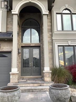 Hamilton (Carpenter) apartment for rent - A grey door with a glass panel and a window above it.