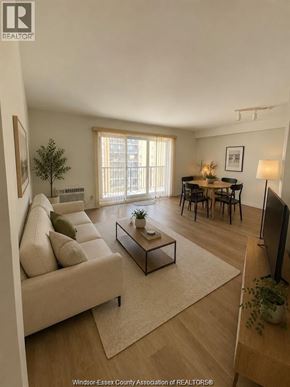 Windsor condo for rent - A living room with a couch, a coffee table, and a television.