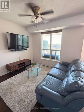 Toronto (Clairlea-Birchmount) condo for rent - A living room with a grey couch and a flat screen TV.