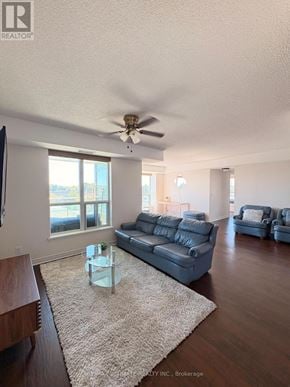 Toronto (Clairlea-Birchmount) condo for rent - A living room with a grey couch and a glass coffee table.