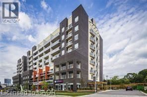 Waterloo condo for rent - A tall residential building with multiple balconies and a clear sky in the background.