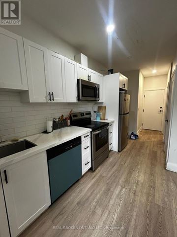 Hamilton (Beasley) apartment for rent - A kitchen with white cabinets and a wooden floor.