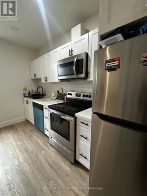 Hamilton (Beasley) apartment for rent - A modern kitchen with stainless steel appliances and white cabinets.