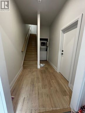 Hamilton (Beasley) apartment for rent - A hallway with wooden floors and white walls.
