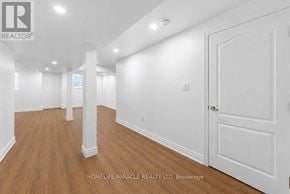 Oshawa (Taunton) apartment for rent - A realtor photo of an empty room with wood floors and white walls.