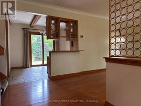 Hamilton (Meadowlands) apartment for rent - A room with wooden floors and a wall with circular patterns on the right side.