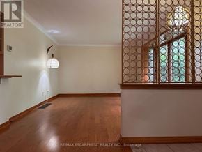 Hamilton (Meadowlands) apartment for rent - A room with wooden floors and a window with a lattice design.