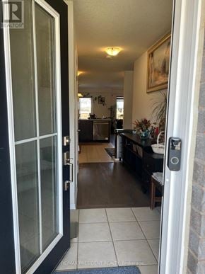 Hamilton (Binbrook) townhouse for rent - A black door with a glass panel is open to a hallway.