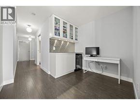 New Westminster apartment for rent - A living room with a television and a cabinet with glass doors.