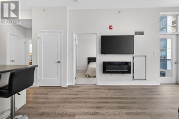 Grimsby (Grimsby Beach) condo for rent - A living room with a television and a fireplace.