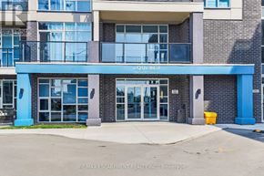 Grimsby (Grimsby Beach) condo for rent - The entrance to a building with a blue and white sign that reads "AQUA BLU".