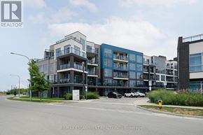 Grimsby (Grimsby Beach) condo for rent - A modern multi-story residential building with balconies and a parking lot in front.