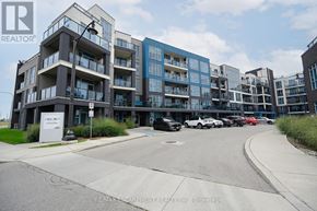 Grimsby (Grimsby Beach) condo for rent - A modern apartment complex with a parking lot in front.