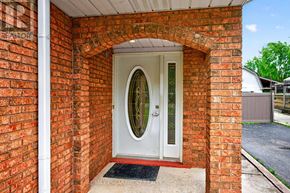 Hamilton (Fruitland) apartment for rent - A white door with a glass window is set in a brick wall.