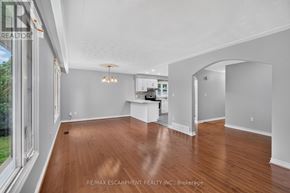 Hamilton (Fruitland) apartment for rent - A spacious room with wooden floors and white walls.