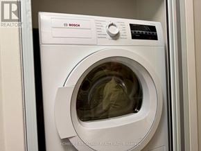 Toronto (Annex) condo for rent - A white Bosch washing machine is shown in a doorway.